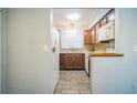 Efficient kitchen with wood cabinets, tile backsplash, and white appliances at 101 N Nimbus Ave, Clearwater, FL 33765