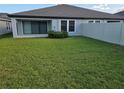 A spacious backyard with lush green grass and a privacy fence, perfect for outdoor activities at 12513 Oak Hill Way, Parrish, FL 34219