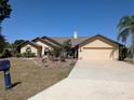 Charming single-story home featuring an attached garage and well-maintained landscaping at 141 Angol St, Punta Gorda, FL 33983