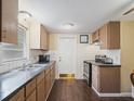 Traditional kitchen featuring essential appliances, ample cabinet space, and laminate countertops at 20703 Old Trilby Rd, Dade City, FL 33523