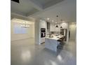 Bright and airy kitchen with an island, stainless steel appliances, and an adjacent dining area at 10153 Wildcat St, Port Charlotte, FL 33981