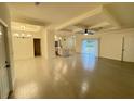 Spacious living room featuring hardwood floors, recessed lighting, and a ceiling fan at 10153 Wildcat St, Port Charlotte, FL 33981