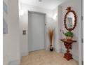 Elevator lobby with elegant mirror, tiled floor, and decorative accents offers convenient and refined building access at 3010 Grand Bay Blvd # 472, Longboat Key, FL 34228