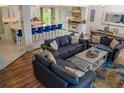 Open concept living room and kitchen with recessed lighting, hardwood floors, and designer furnishings at 328 6Th Ave, Indian Rocks Beach, FL 33785