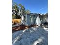 Well-maintained single-story home with light blue siding and concrete driveway at 5015 N 29Th St, Tampa, FL 33610
