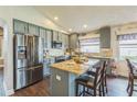 Stylish kitchen with stainless steel appliances, granite countertops, and a functional center island at 6935 Runner Oak Dr, Wesley Chapel, FL 33545