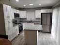 Modern kitchen with white cabinets, stainless steel appliances, and granite countertops at 8114 Oak Trace Way # C, Tampa, FL 33634