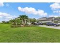 Charming single-Gathering home featuring a three-car garage, tropical landscaping, and a paved driveway able to accommodate multiple vehicles at 17204 Bullhorn Cir, Punta Gorda, FL 33982