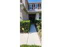 Landscaped walkway leading to the front door of a charming two-story home at 7620 Tangle Rush Dr, Gibsonton, FL 33534