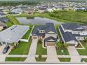 Expansive aerial view showcases the home's location near a pond and neighborhood amenities at 7163 Talamore Dr, Wesley Chapel, FL 33545