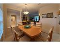 An inviting dining area features stylish furnishings, a warm color palette, and neutral-toned chairs at 10937 Bluestem Cir, Lakewood Ranch, FL 34202