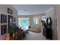 An open concept home shows the living area with decor and a view of the outdoor pool at 10937 Bluestem Cir, Lakewood Ranch, FL 34202