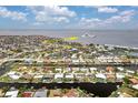 Waterfront property with canal access with a yacht in the distance at 1764 Boca Raton Ct, Punta Gorda, FL 33950
