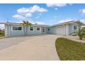 Single-story home featuring a spacious driveway and attached two-car garage at 1764 Boca Raton Ct, Punta Gorda, FL 33950