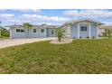 Well-maintained single-story home with lush green lawn and inviting curb appeal at 1764 Boca Raton Ct, Punta Gorda, FL 33950