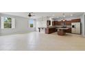Spacious kitchen with brown cabinetry, stainless steel appliances, granite countertops, and an island at 20214 Water Hickory Pl, Tampa, FL 33647