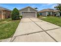 Beautiful single-story home with a well-manicured lawn and a spacious driveway at 2936 Banyan Hill Ln, Land O Lakes, FL 34639