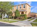 Charming two-story home with a detached garage and a well-manicured lawn at 32717 Coldwater Creek Loop, Wesley Chapel, FL 33545