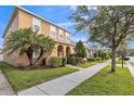 A street view of a two-story home with a stucco exterior and well-kept landscaping at 32717 Coldwater Creek Loop, Wesley Chapel, FL 33545