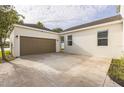 Large two car garage with an expansive driveway at 5254 Suncatcher Dr, Wesley Chapel, FL 33545