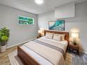 Cozy bedroom with natural light, soft neutral tones, and stylish décor with hardwood flooring at 103 4Th Nw Ave, Lutz, FL 33548