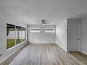 Spacious living room showcasing wood-look floors and natural light at 103 4Th Nw Ave, Lutz, FL 33548
