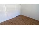 Bedroom featuring wood-look floors and closet at 1122 Montrose Pl # 1713, Dunedin, FL 34698