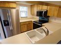 Kitchen featuring stainless steel appliances and ample counter space at 1122 Montrose Pl # 1713, Dunedin, FL 34698