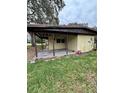 Features a covered back porch, providing an outdoor living space with a concrete base and wood supports at 5026 Osprey Ln, New Port Richey, FL 34652
