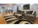Spacious living room featuring a large sectional sofa, a patterned rug, and access to the kitchen at 19700 Gulf Blvd # 204, Indian Shores, FL 33785