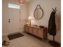 Bright entryway with decorative elements, a woven pendant light, and neutral wall tones at 2913 Suncoast Plains Dr, Odessa, FL 33556