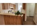 Kitchen with breakfast bar area and tile floor leading to entrance area at 6600 121St Ave # 5, Largo, FL 33773
