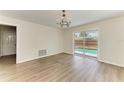 Dining room with light wood floors and sliding glass doors that overlook the pool at 221 Vermont E Ave, Bradenton, FL 34208