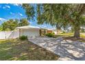 Exterior view of a single story home featuring a well-maintained front yard and two-car garage at 2521 Carlisle Pl, Sarasota, FL 34231