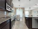 Modern kitchen featuring stainless steel appliances, granite countertops, tile backsplash and open design at 26835 Juniper Bay Dr, Wesley Chapel, FL 33544