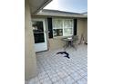Outdoor patio features tiled floor, small table set, and a decorative dolphin mosaic at 13725 Plumosa Ave, Hudson, FL 34667