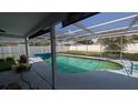 A view of the private screened-in pool with an outdoor lounging area at 249 Malvern Dr, Venice, FL 34293
