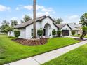 Beautiful one-story home with manicured lawn and lush landscaping, creating inviting curb appeal at 9246 Dayflower Dr, Tampa, FL 33647