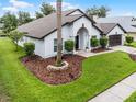 Inviting one-story home with a lush lawn, attractive landscaping and a neatly maintained exterior at 9246 Dayflower Dr, Tampa, FL 33647