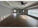 Large living room featuring a stone fireplace and modern ceiling fans at 1801 Hibiscus S Ct, Oldsmar, FL 34677