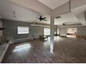 Spacious living room with hardwood floors, ceiling fans, and ample natural light at 1801 Hibiscus S Ct, Oldsmar, FL 34677
