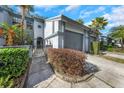 Well-maintained townhome featuring an attached one-car garage and a private gated entrance at 4239 Brentwood Park Cir, Tampa, FL 33624