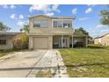 Two-story home featuring a single-car garage and covered front porch at 6310 Cecelia Dr, New Port Richey, FL 34653