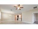 Expansive living area featuring tile flooring and recessed lighting, connecting seamlessly to the adjacent kitchen at 13209 Haystack Ct, Riverview, FL 33579