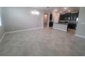 Open floor plan with tile flooring connecting the living room, dining area, and kitchen at 13209 Haystack Ct, Riverview, FL 33579
