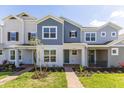 Attractive townhome with blue and gray exterior, covered porch, and well-maintained landscaping at 17330 Alderwood Ln, Punta Gorda, FL 33982