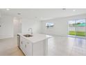 Bright eat-in kitchen featuring stainless steel appliances and tile flooring at 1817 Draughton Dr, Zephyrhills, FL 33541