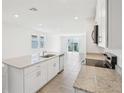 Open-concept kitchen showcasing a central island, granite countertops, and stainless dishwasher at 3539 Moscato Dr, Brooksville, FL 34602