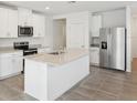 Modern kitchen featuring an island, stainless steel appliances, and granite countertops at 3539 Moscato Dr, Brooksville, FL 34602