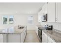 Bright, modern kitchen with granite countertops, stainless steel appliances, and plenty of natural light at 3547 Moscato Dr, Brooksville, FL 34602